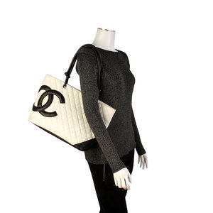 https://dbiyorq10n2b9.cloudfront.net/product-images/BAGCH116/CHANEL-Quilted-Leather-Ligne-Cambon-Large-Tote-White-mannequin.jpg.webp