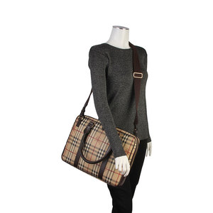 https://dbiyorq10n2b9.cloudfront.net/product-images/CBAGBUR200/BURBERRY-Haymarket-Check-Laptop-Bag-Brown-mannequin.jpg.webp