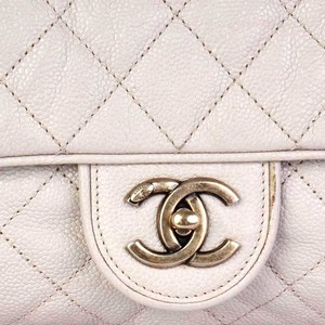 https://dbiyorq10n2b9.cloudfront.net/product-images/CBAGCH118/CHANEL-Quilted-Glazed-Caviar-Leather-Large-Shiva-Flap-Bag-Beige-close-up-2.jpg.webp