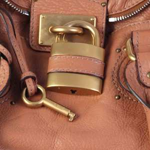 https://dbiyorq10n2b9.cloudfront.net/product-images/CBAGCHLO101/CHLOE-Brown-Leather-Medium-Paddington-Satchel-Pad-Lock-close-up.jpg.webp