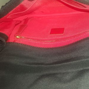 https://dbiyorq10n2b9.cloudfront.net/product-images/CBAGCL0003/CHRISTIAN-LOUBOUTIN-Canvas-Patch-Letters-Riviera-Clutch-Black-interior.jpg.webp