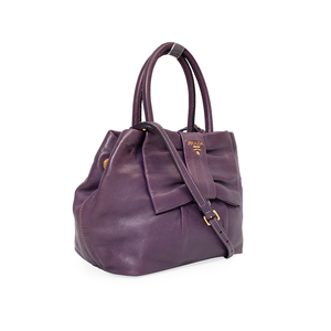 https://dbiyorq10n2b9.cloudfront.net/product-images/CBAGPRA0042/PRADA-Nappa-Fiocco-Bow-Bag-Purple-Angle.jpg.webp