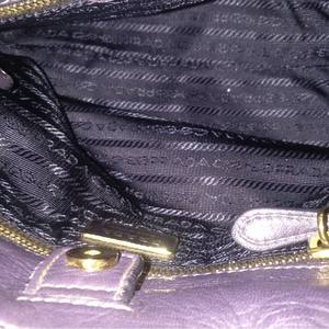 https://dbiyorq10n2b9.cloudfront.net/product-images/CBAGPRA0042/PRADA-Nappa-Fiocco-Bow-Bag-Purple-interior.jpeg.webp