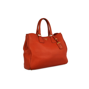 https://dbiyorq10n2b9.cloudfront.net/product-images/CBAGPRA159/PRADA-Pebbled-Leather-Tote-Orange-angle.jpg.webp