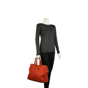 https://dbiyorq10n2b9.cloudfront.net/product-images/CBAGPRA159/PRADA-Pebbled-Leather-Tote-Orange-mannequin.jpg.webp