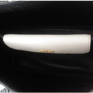 https://dbiyorq10n2b9.cloudfront.net/product-images/CBAGPRA182/PRADA-Saffiano-Cuir-Small-Double-Bag-White-NEW-interior-1.jpg.webp