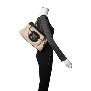 https://dbiyorq10n2b9.cloudfront.net/product-images/CBAGTOD0022/TODS-Leather-Canvas-Shoulder-Bag-Black-Ivory.jpg.webp